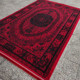 نمای زاویهدار از فرش روی زمین: فرش صدف لاکی تراکم ۱۵۰۰ در محیط منزل، با رنگ لاکی درخشان و نقشهای سنتی که گرما و صمیمیت به فضا میبخشد.